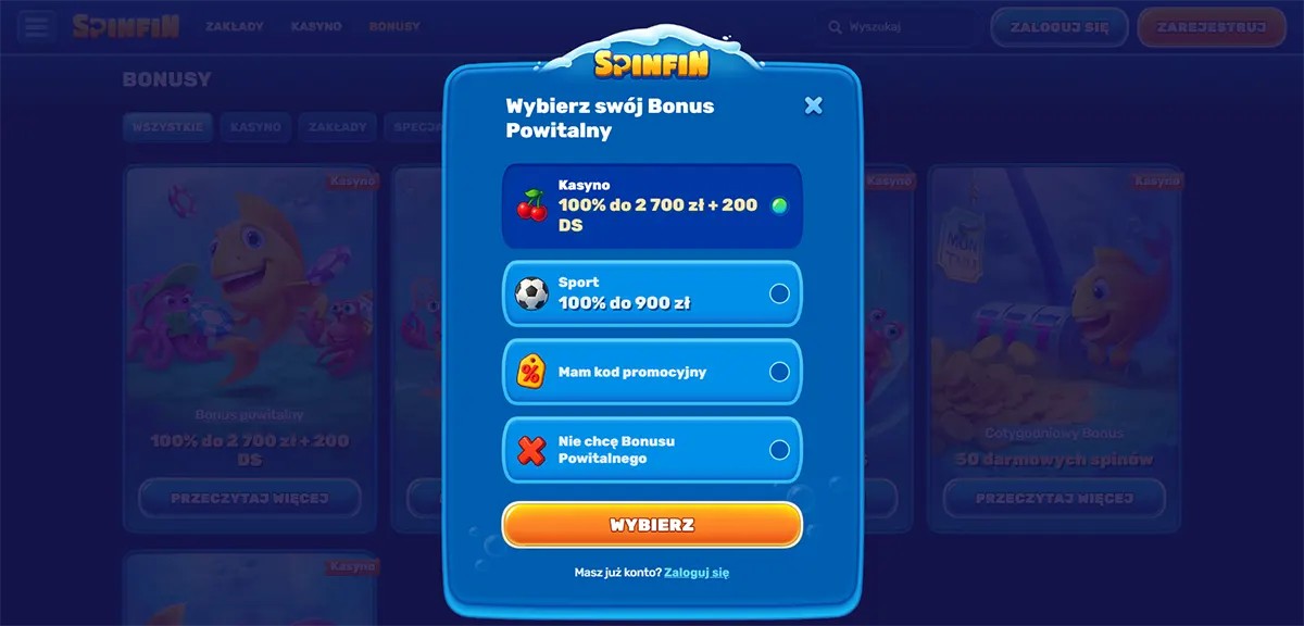 Welcome bonus selection modal (Polish localisation) for Spinfin Casino, allowing users to choose between a casino bonus (100% do 2 700 zł + 200 darmowych spinów), a sports bonus (100% do 900 zł), entering a promo code, or declining the bonus, with a prominent “Wybierz” button and login option below